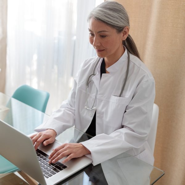 Medical specialist working on laptop at office